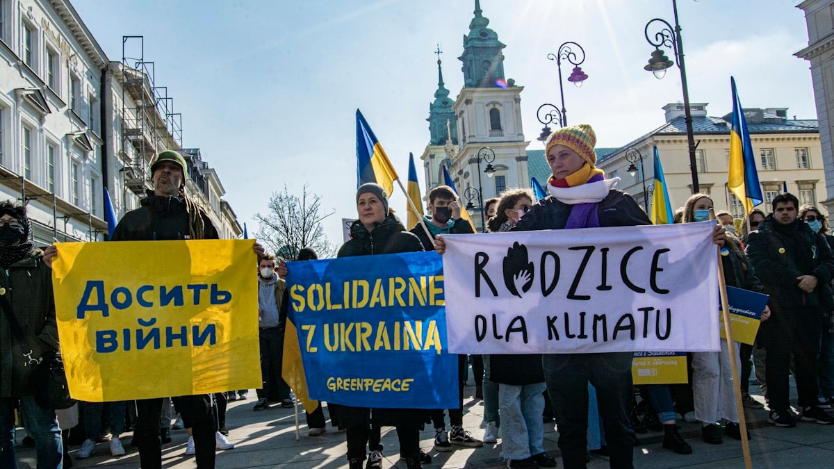 a group of people holding signs in a protest